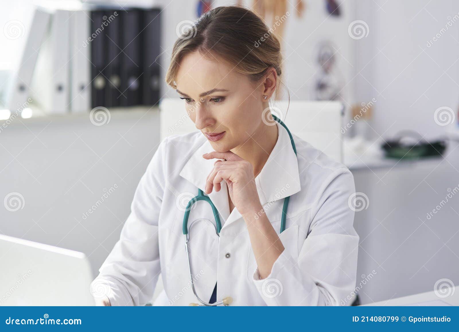 female doctor working with laptop in her doctorÃ¢â¬â¢s office